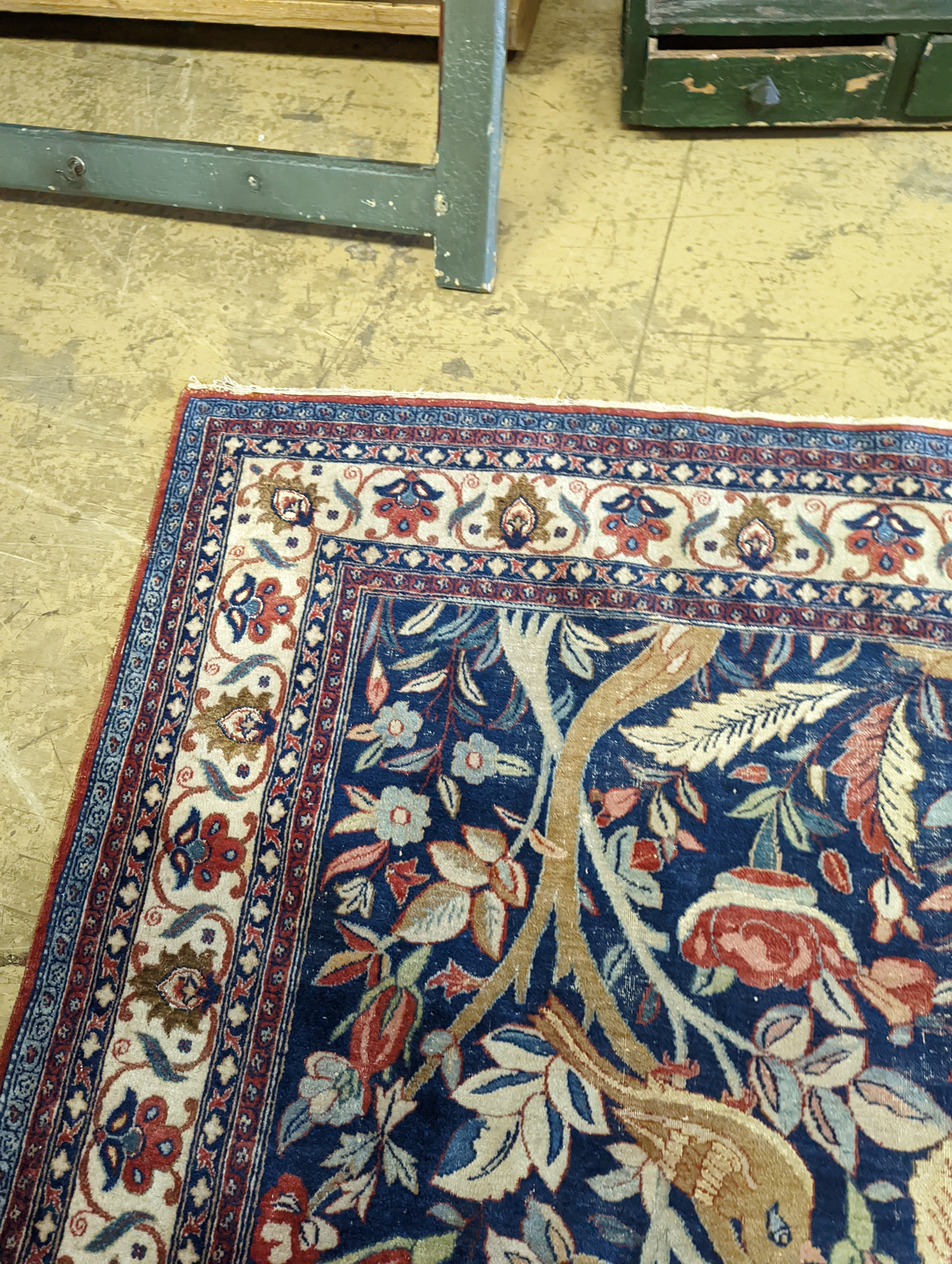 A Kirman blue ground rug woven with birds amongst flowering branches, 205 x 136cm